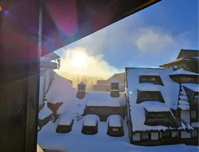 a window view of a house covered in snow at Celestis Apartmani Konaci in Kopaonik