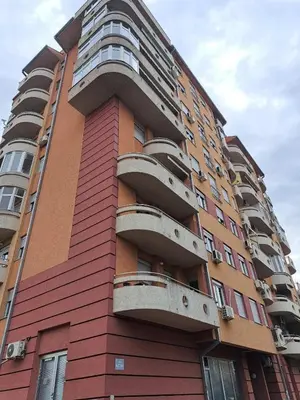 a tall building with balconies on the side of it at V&V Apartments in Niš