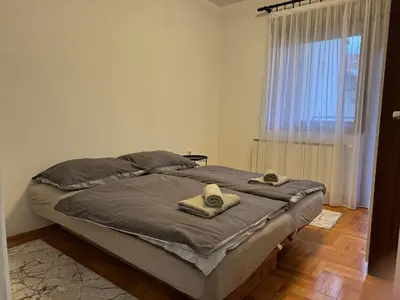 a bed with two towels on it in a bedroom at V&V Apartments in Niš