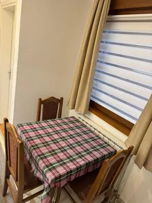 a table and chairs with a table and a window at V&V Apartments in Niš