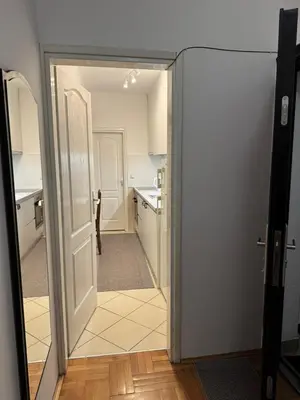 an open door to a kitchen with a hallway at V&V Apartments in Niš