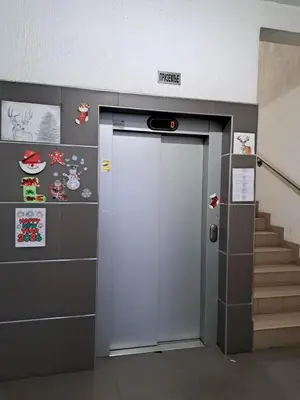 an elevator with a door in a building with stairs at V&V Apartments in Niš