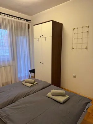 a bedroom with a bed with two towels on it at V&V Apartments in Niš