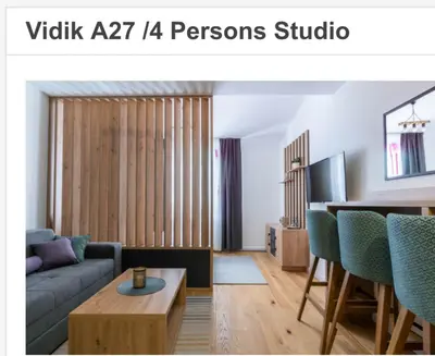 a living room with a couch and a table at Apartman Vidik Residence A27 Kopaonik in Kopaonik