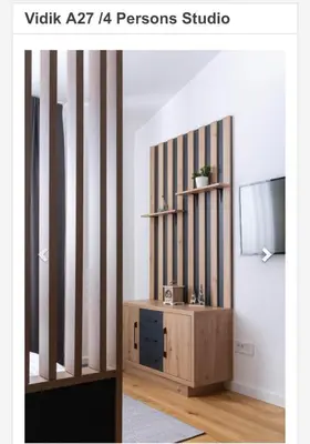 a room with a tv and a wooden cabinet at Apartman Vidik Residence A27 Kopaonik in Kopaonik