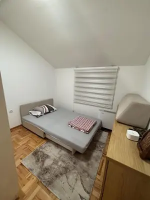 a small room with a bed and a window at Comfortable Nis Apartment in Niš