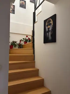 a stairway with a picture of a woman on the wall at Comfortable Nis Apartment in Niš