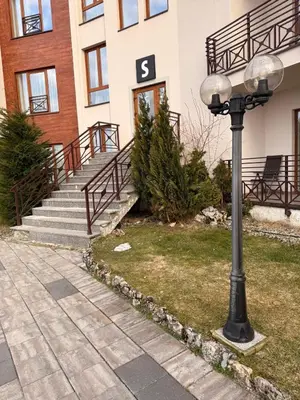 a street light in front of a building with stairs at Mountain Nest - Milmari Resort & Spa in Kopaonik