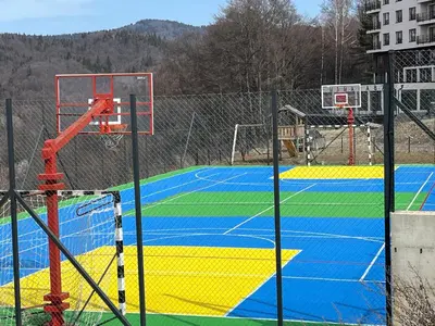 a basketball court with a basketball hoop on it at Mountain Nest - Milmari Resort & Spa in Kopaonik