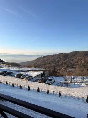 a group of cars parked in a snow covered field at Mountain Nest - Milmari Resort & Spa in Kopaonik