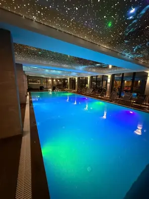 a swimming pool in a building with a star ceiling at Mountain Nest - Milmari Resort & Spa in Kopaonik