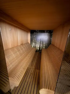 a sauna with two benches in a room with a window at Mountain Nest - Milmari Resort & Spa in Kopaonik