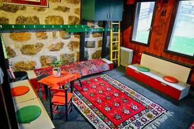 a room with a table and chairs and a room with a table and a table at 369 Vila in Pirot