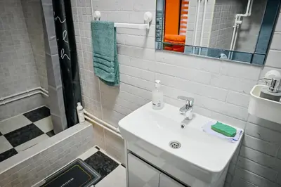 a white bathroom with a sink and a shower at 369 Vila in Pirot