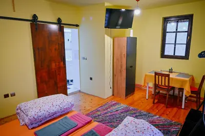 a living room with a couch and a table with a tableablish at 369 Vila in Pirot