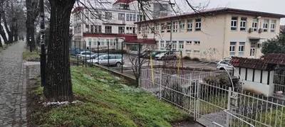 a fence in front of a street with cars parked at 369 Vila in Pirot