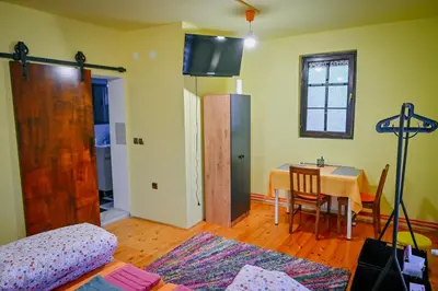 a living room with a table and a dining room at 369 Vila in Pirot