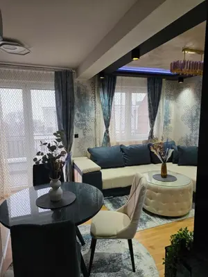a living room with a couch and a table at APARTMAN POSEJDON DELUXE- EXCLUSIVe in Vrnjačka Banja