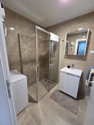 a bathroom with a shower and a toilet and a sink at APARTMAN POSEJDON DELUXE- EXCLUSIVe in Vrnjačka Banja