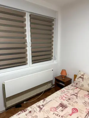a bedroom with a window with blinds at Tim in Kalna