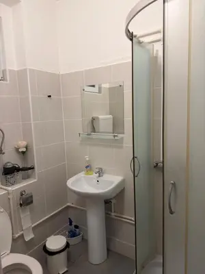 a bathroom with a sink and a toilet and a mirror at Tim in Kalna