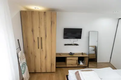 a bedroom with a wooden cabinet with a television on it at Bakina kuca in Pirot