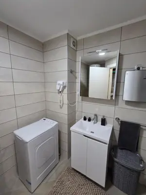 a bathroom with a toilet and a sink and a mirror at POSEJDON DELUXe 4 in Vrnjačka Banja
