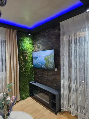 a living room with a tv on a brick wall at POSEJDON DELUXe 4 in Vrnjačka Banja