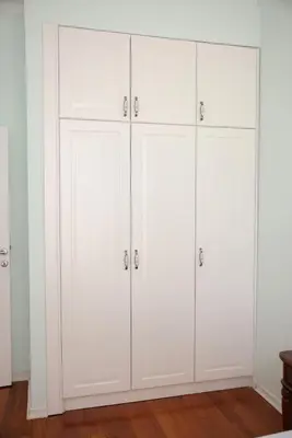 a row of white cabinets in a room at Apartman A4 - Vila Opera in Vrnjačka Banja