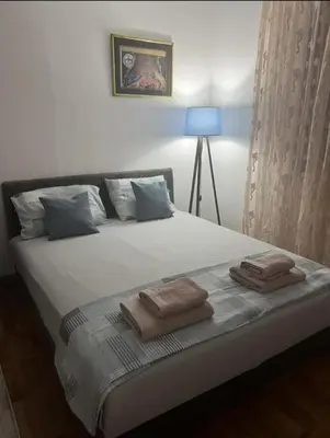 a bedroom with a bed with two towels on it at emem in Kuršumlija
