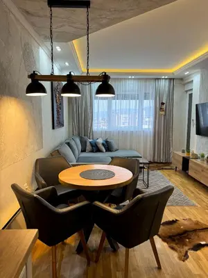 a living room with a couch and a table at Royal apartmani 42 in Vrnjci