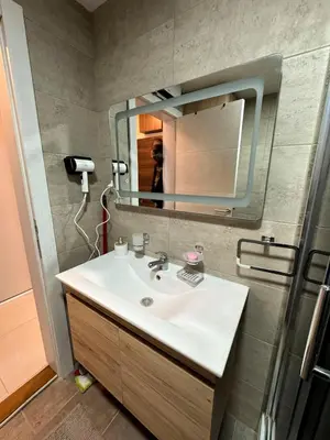 a bathroom with a sink and a mirror at Royal apartmani 42 in Vrnjci