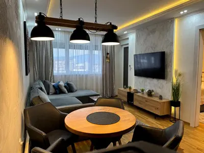 a living room with a couch and a table at Royal apartmani 42 in Vrnjci