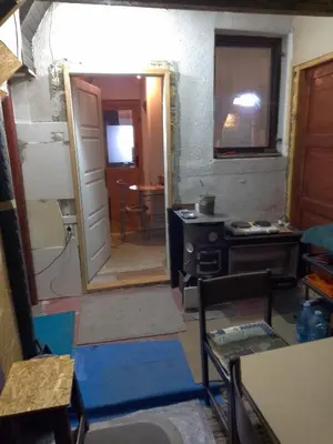 a room with a door and a kitchen with a table at KOPANIKSkiRooms in Kopaonik