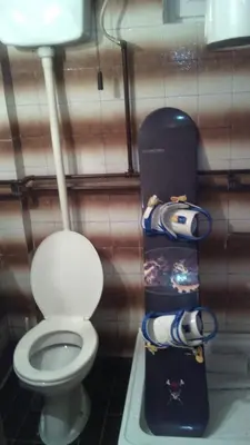 a bathroom with a toilet and a snowboard next to it at KOPANIKSkiRooms in Kopaonik