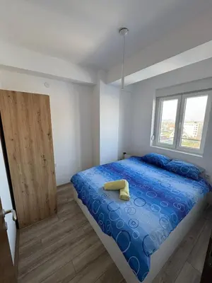 a bedroom with a bed with a yellow shoe on it at Apartman Vera in Trnava