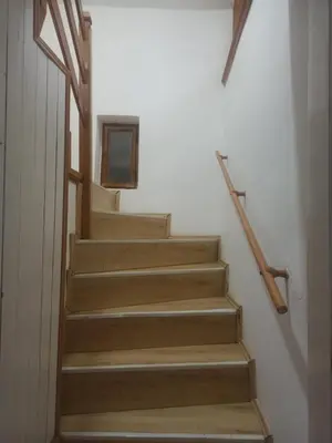 a stairway with wooden steps in a building at Apartmani Jelena 6 in Vrnjačka Banja