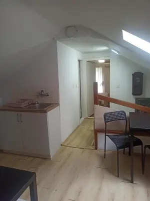 a kitchen with a sink and a table and chairs at Apartmani Jelena 6 in Vrnjačka Banja