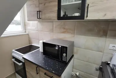 a small kitchen with a black microwave on a counter at Apartman Danica in Vrnjačka Banja