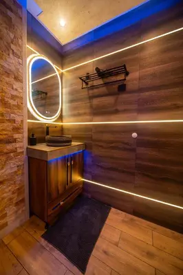a bathroom with a mirror and a wooden wall at Ryo Golden Imperial 2 in Kruševac