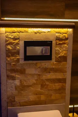 a brick wall with a fire place in a bathroom at Ryo Golden Imperial 2 in Kruševac
