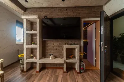 a room with a tv on a brick wall at Ryo Golden Imperial 2 in Kruševac