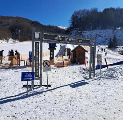 a sign in the snow in front of a ski slope at Zimski san in Brzeće