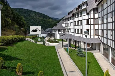 a view of a building with a grass yard at Zimski san in Brzeće