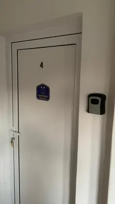 a door with a sign on it next to a wall at Apartman Javor in Vrnjačka Banja