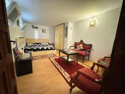 a living room with a bed and a table and chairs at Airport, Belgrade, 1 bedroom, 1 living room in Bukorovac