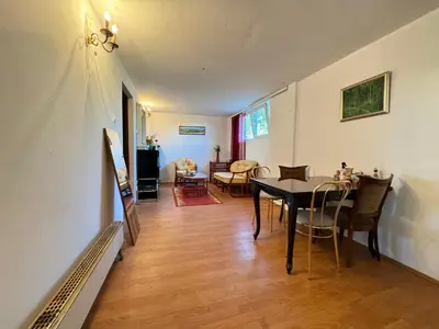 a dining room and living room with a table and chairs at Airport, Belgrade, 1 bedroom, 1 living room in Bukorovac