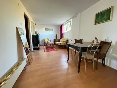 a dining room and living room with a table and chairs at Airport, Belgrade, 1 bedroom, 1 living room in Bukorovac