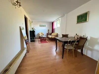 a dining room and living room with a table and chairs at Airport, Belgrade, 1 bedroom, 1 living room in Bukorovac