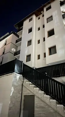 a tall building with a black fence in front of it at Apartman Ivana Kopaonik in Kopaonik